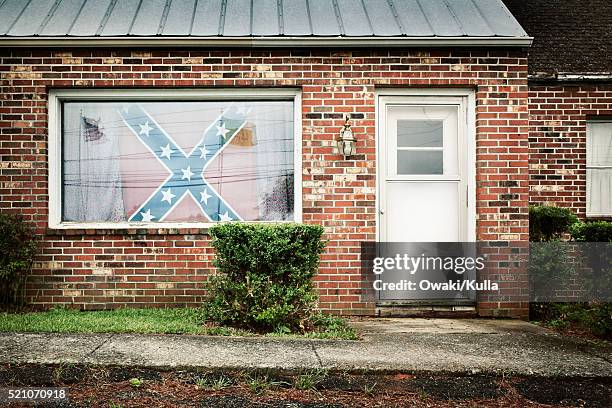 confederate flag displayed in house window - confederate flag stock pictures, royalty-free photos & images