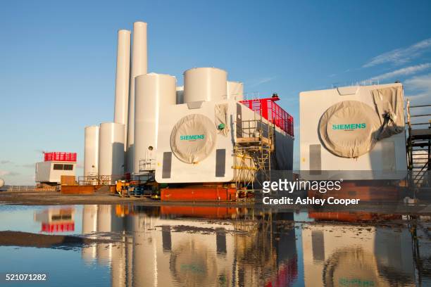 wind turbine parts for the walney offshore wind farm on the dock side at mostyn in north wales. - siemens stock pictures, royalty-free photos & images