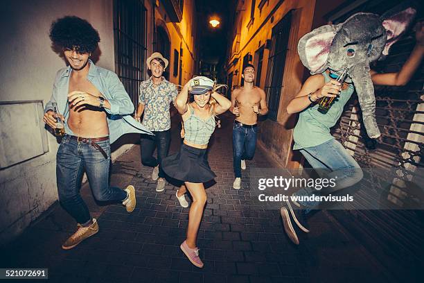 teenagers running down street during night party - hipster costume stock pictures, royalty-free photos & images