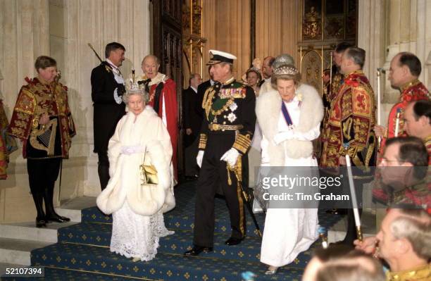 The Queen With Prince Philip And The Duchess Of Grafton At The House Of Lords For The State Opening Of Parliament. In Red Robes At Back Is The Duke...
