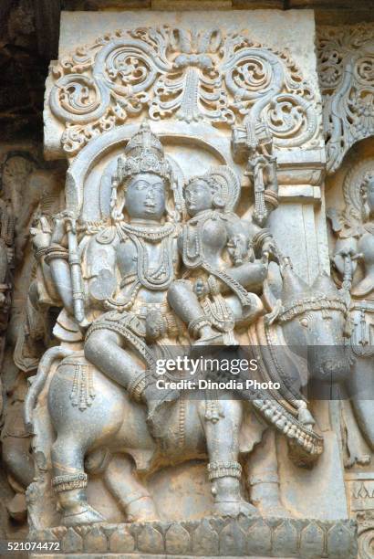 statue of lord shiva parvati sitting on nandi or bull at shiva temple, halebidu, district hassan, karnataka, india - sitting shiva stock pictures, royalty-free photos & images