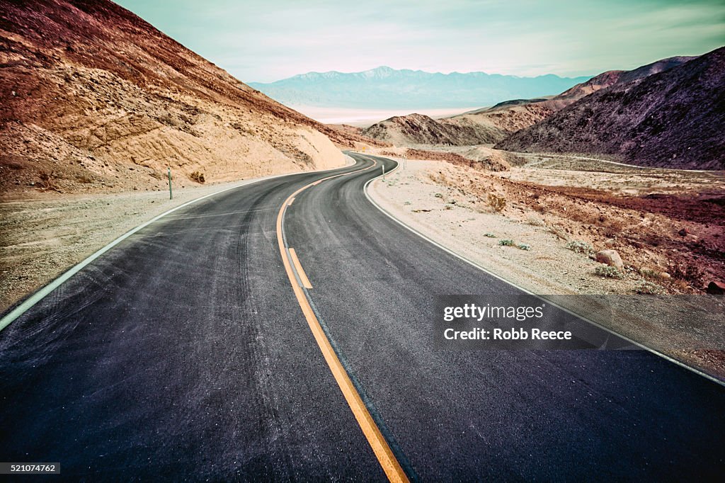 A desolate, winding, paved highway in Death Valley, CA