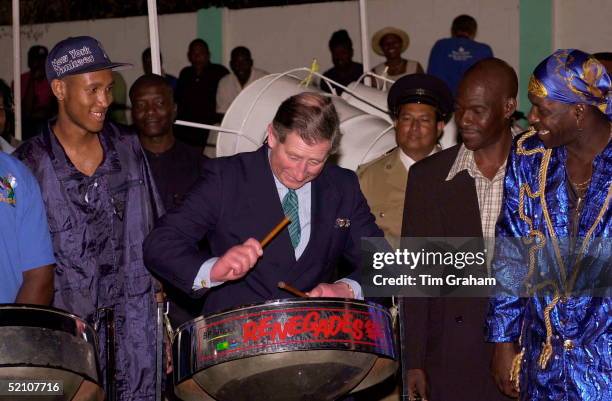 Prince Charles In Port Of Spain, Trinidad Playing One Of The Steel Drums Used In A Steel Band Concert At The Bp Amoco Pan Yard To Greet His Arrival.