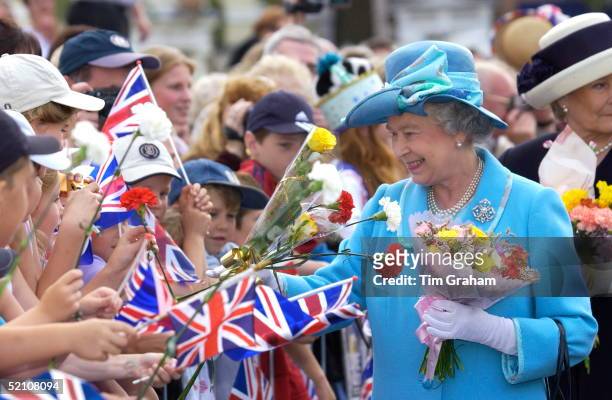 Queen Elizabeth II Smiling As She Continues Her Jubilee Tour Greeting Crowds Of Well-wishers With Union Jack Flags And Receiving Flowers.