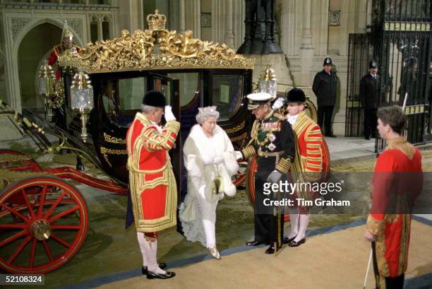 The Queen And Prince Philip Arrive In The Irish State Coach At The House Of Lords For The State Opening Of Parliament. Prince Philip Helps The Queen...