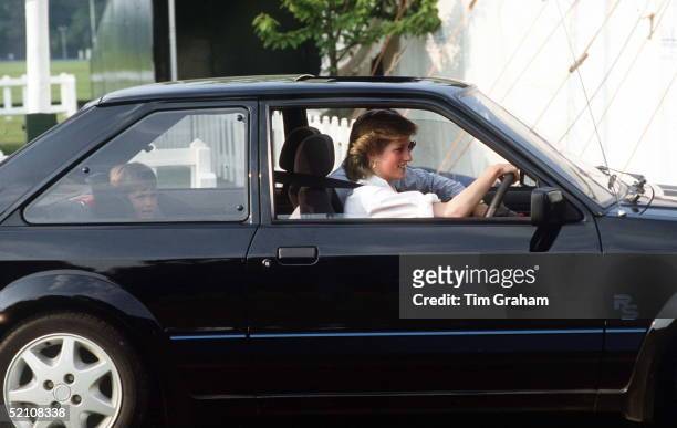 Princess Diana Driving Her Ford Escort With Prince William Sitting In A Special Car Seat Behind