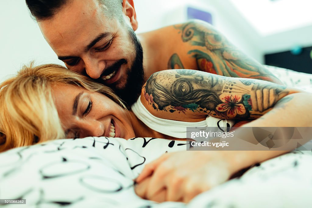 Tattooed Couple Flirting In Bed.