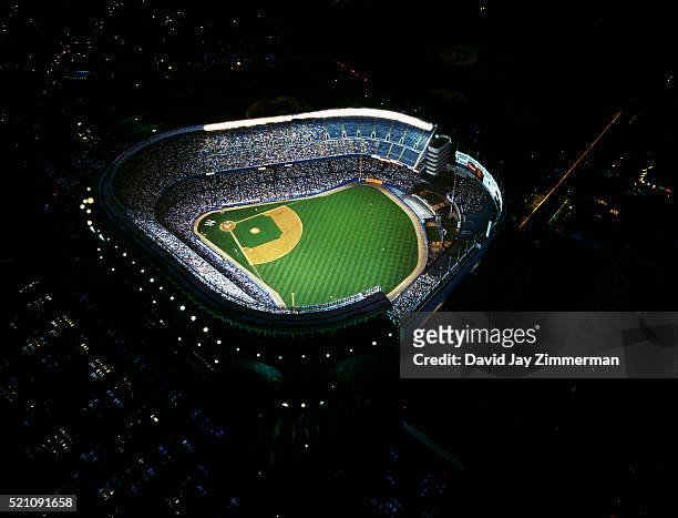 aerial of yankee stadium illuminated at night - yankee stadium night stock pictures, royalty-free photos & images