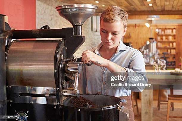 young woman using coffee roaster - 焙煎 ストックフォトと画像