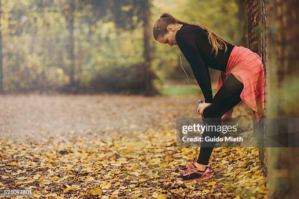 woman taking rest after jogging. - germany womens training stockfoto's en -beelden