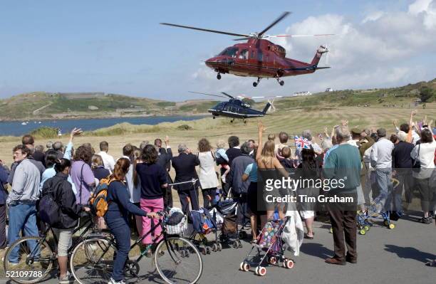 Crowds Watching And Waving As The Queen Is Leaving The Island Of Alderney In Her Royal Flight Helicopter During Her Visit To The Channel Islands
