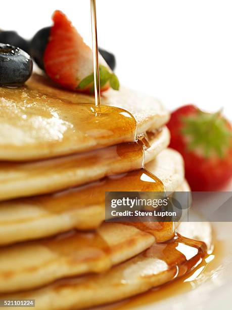 pouring syrup over a stack of pancakes - maple syrup pancakes stock pictures, royalty-free photos & images