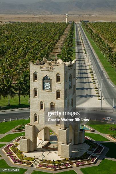 salalah clock tower in traffic circle - oman-clock-tower stock pictures, royalty-free photos & images