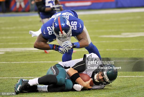 Antrel Rolle of the New York Giants tackles Mark Sanchez of the Philadelphia Eagles during an NFL football game at MetLife Stadium on December 28,...