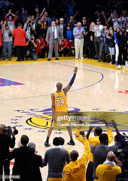 Kobe Bryant of the Los Angeles Lakers waves to the crowd as he is taken out of the game after scoring 60 points against the Utah Jazz at Staples...