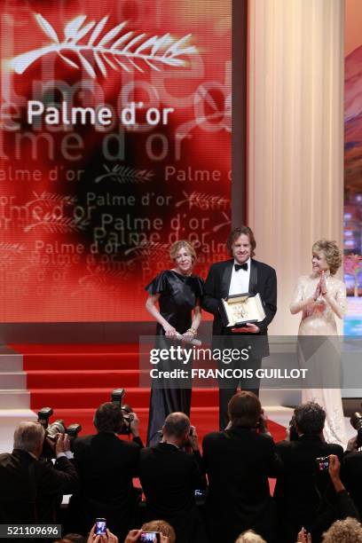 Producers Bill Pohlad and Dede Gardner pose next to US actress Jane Fonda as they received on behalf of US director Terrence Malick the Palme D'Or...