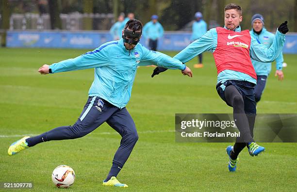 Vedad Ibisevic of Hertha BSC shoots the ball next to Jens Hegeler of Hertha BSC during the training of Hertha BSC on april 14, 2016 in Berlin,...