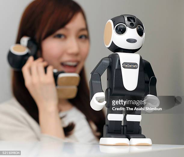 Model displays a robot-shaped mobile phone 'RoBoHon' during a press conference on April 14, 2016 in Tokyo, Japan. Designed by robot creator Tomotaka...