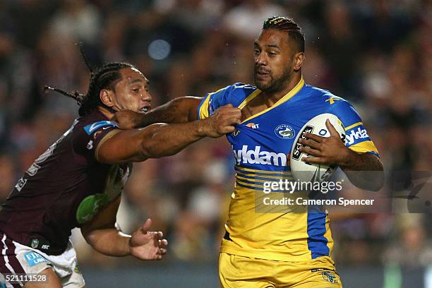 Kenneth Edwards of the Eels is tackled by Martin Taupau of the Sea Eagles during the round seven NRL match between the Manly Sea Eagles and...