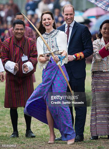 Catherine, Duchess of Cambridge and Prince William react are taking part in archery at Thimphu's open-air archery venue on April 14, 2016 in Thimphu,...