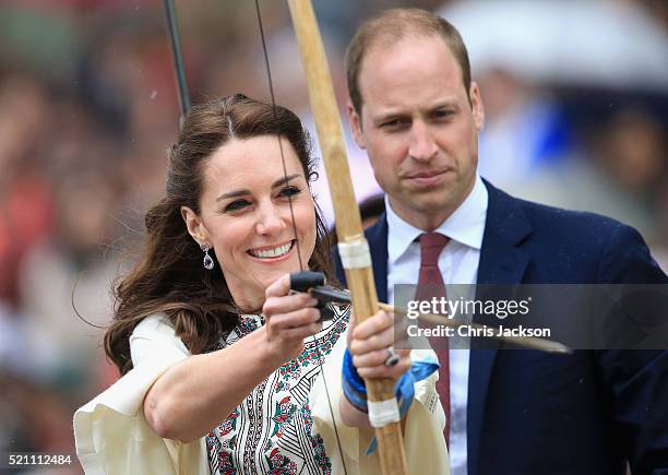 Prince William, Duke of Cambridge looks on as Catherine, Duchess of Cambridge fires an arrow during an Bhutanese archery demonstration on the first...