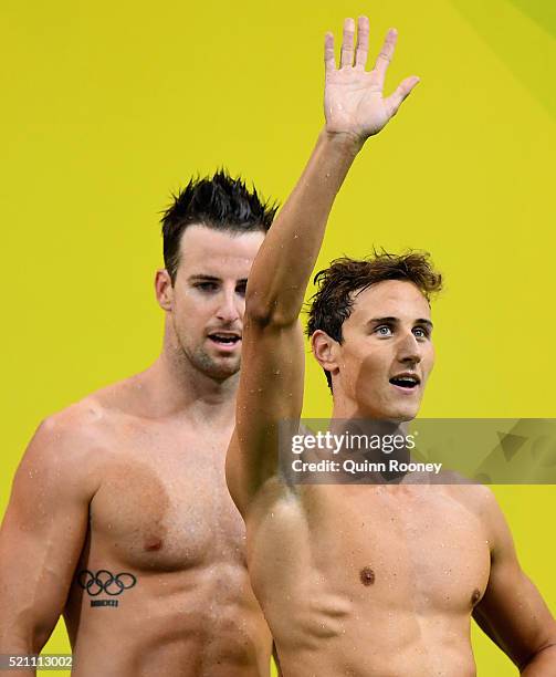 Cameron McEvoy of Australia waves to the crowd as he and James Magnussen walk from the pool after competing in the 4 x 100 metre Freestyle Relay...