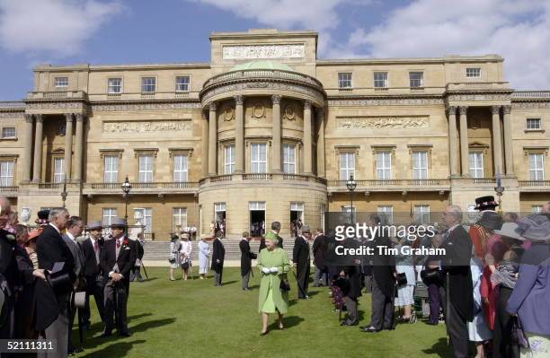 Buckingham Palace Garden Party. The Queen Meeting Guests. Gentlemen Ushers Wait To Make The Introductions.