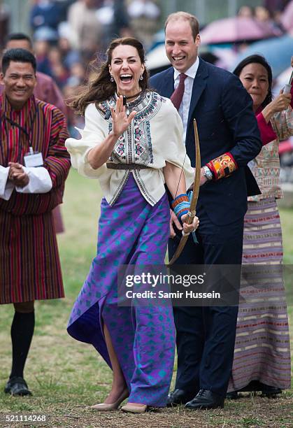 Catherine, Duchess of Cambridge and Prince William react as they take part in archery at Thimphu's open-air archery venue on April 14, 2016 in...