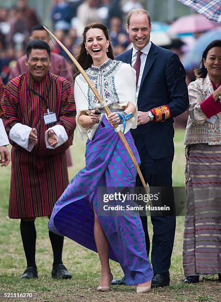 Catherine, Duchess of Cambridge and Prince William react as they take part in archery at Thimphu's open-air archery venue on April 14, 2016 in...