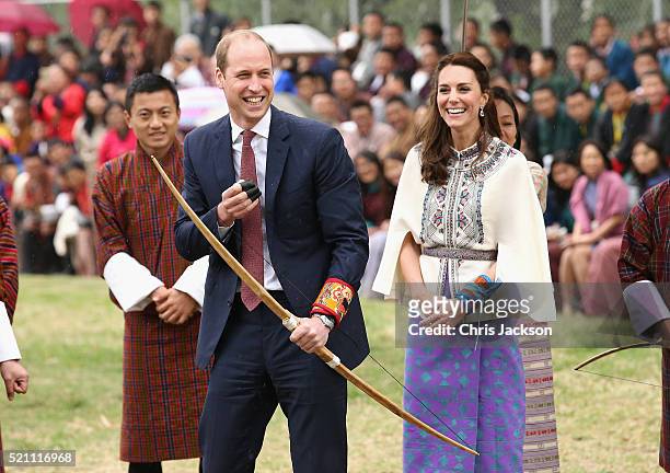 Prince William, Duke of Cambridge fires an arrow as Catherine, Duchess of Cambridge looks on during an Bhutanese archery demonstration on the first...