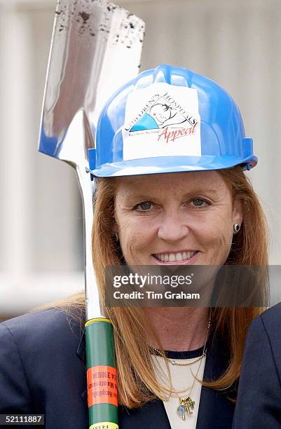 Sarah, Duchess Of York, Is Wearing A Hard Hat And Carrying A Spade Over Her Shoulder To Open The New Parental Accommodation In The Neo Natal Unit At...