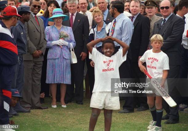 The Queen Watching Cricket At Langa Cricket Club .bodyguard Peter Prentice Behind Her Shoulder And Behind Him In Light Shirt Is Sir Robert Fellowes...
