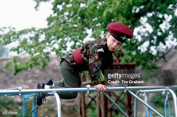 Prince William In The Uniform Of The Parachute Regiment Playing On A Climbing Frame At His Home Highgrove In Gloucestershire.