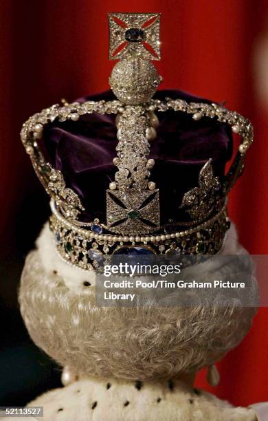 Queen Elizabeth Wears The Imperial Crown As She Walks Through The Royal Gallery In The House Of Lords During The State Opening Of Parliament.