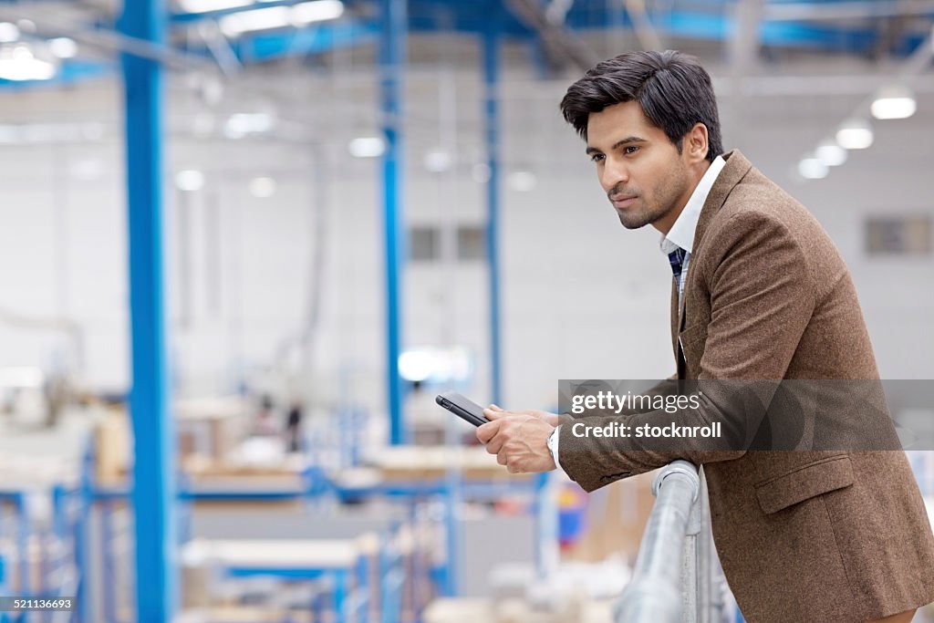 Male executive on factory balcony