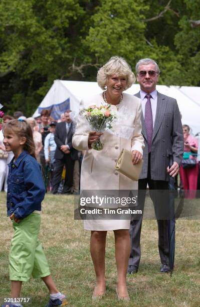 Camilla Parker-bowles Smiling At The Sandringham Flower Show. It Is Her First Official Walkabout.with Her Is Police Bodyguard Reg Spinney