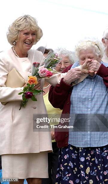 Camilla Parker-bowles Laughing At The Sandringham Flower Show As A Woman In The Crowd, 77 Year-old Dorothy Edwards, Kisses Her Hand. She Is Holding...