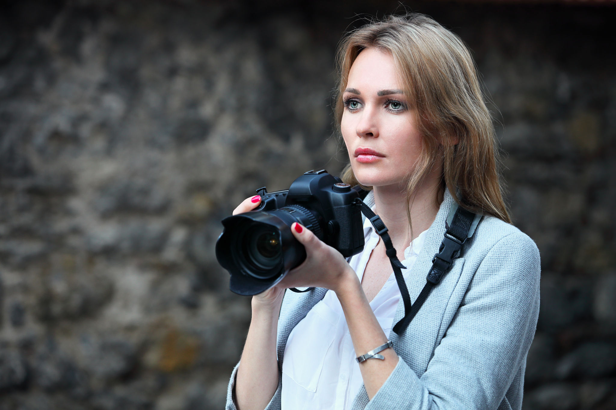 Beautiful woman photographer taking photos in the city Beautiful woman photographer taking photos in the city