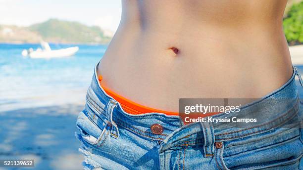 close-up of woman's belly button in swimsuit - belly button ストックフォトと画像