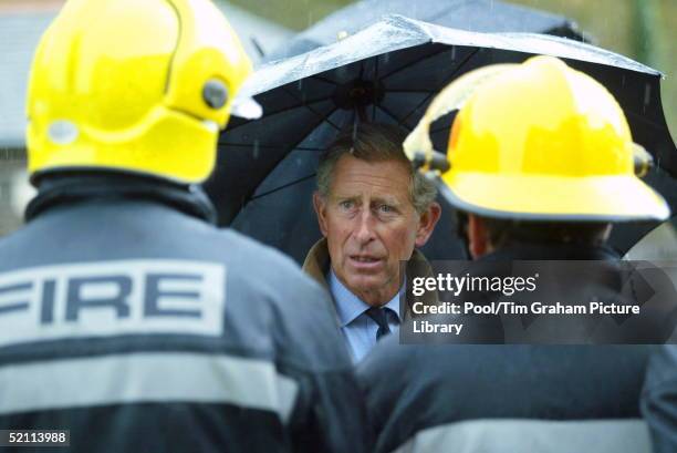 Prince Charles Meets Emergency Service Fire Brigade Personnel In Boscastle, Cornwall After Many Homes Were Demolished By A Torrent Of Water Which...