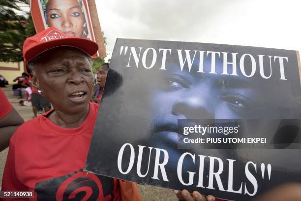 Member of "Bring Back Our Girls" movement carries placard to press for the release of the missing Chibok schoolgirls in Lagos, on April 14, 2016. -...