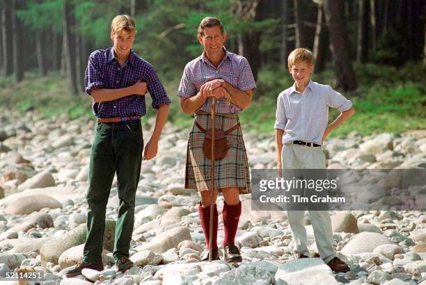 Prince Charles Holding A Walking Stick Styled As A Shepherd's Crook Stick With Prince William And Prince Harry At Polvier, By The River Dee, Balmoral...