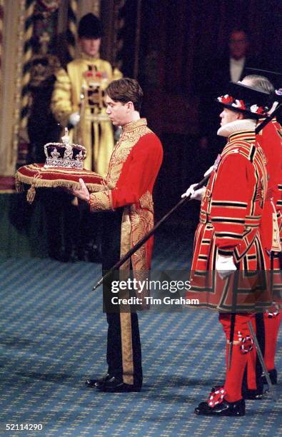 The Marquess Of Cholmondeley, The Lord Great Chamberlain, Accompanied By Yeomen Of The Guard Carrying The Imperial State Crown At The State Opening...