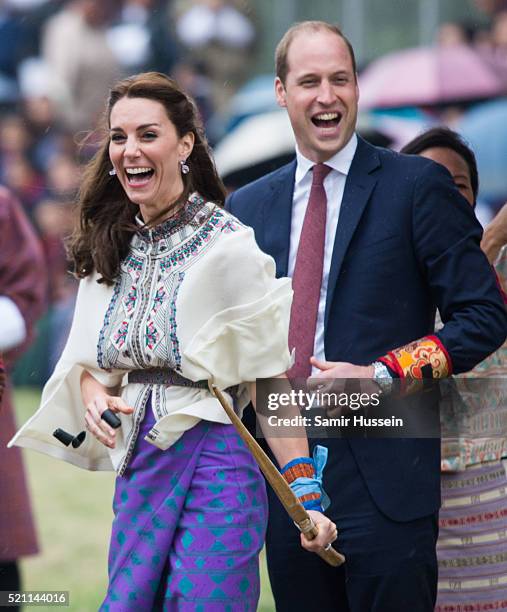 Catherine, Duchess of Cambridge and Prince William react as they take part in archery at Thimphu's open-air archery venue on April 14, 2016 in...