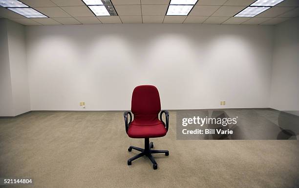office chair in empty room - bankruptcy stock pictures, royalty-free photos & images