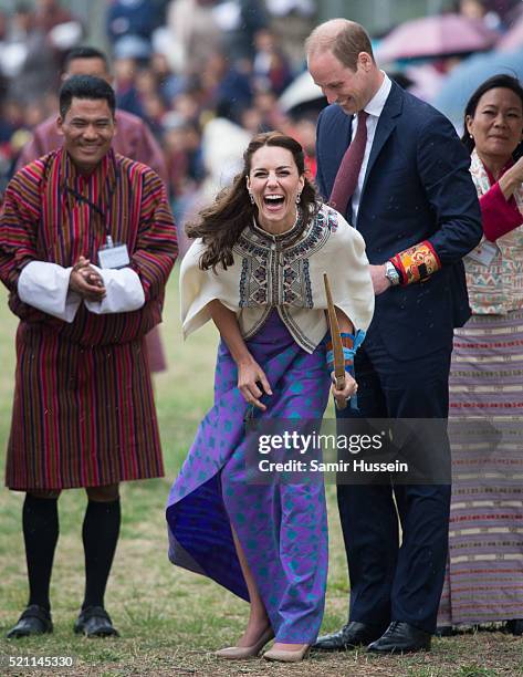 Catherine, Duchess of Cambridge and Prince William react as they take part in archery at Thimphu's open-air archery venue on April 14, 2016 in...