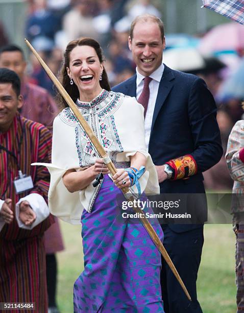 Catherine, Duchess of Cambridge and Prince William react as they take part in archery at Thimphu's open-air archery venue on April 14, 2016 in...