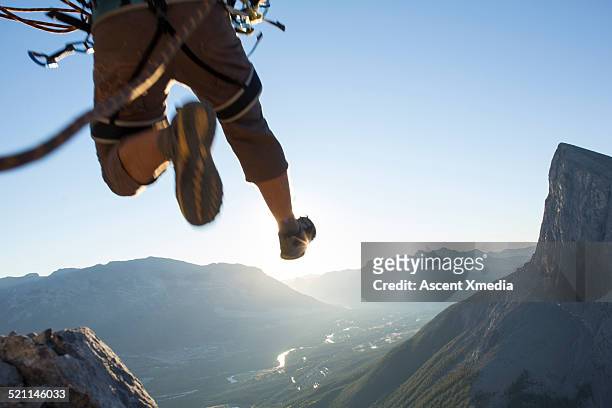 mountaineer in mid air leap above mountains - leap of faith activity bildbanksfoton och bilder