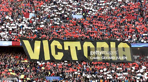 Banner reading "Victory" is displayed by the Atletico's fans prior the Champions League quarter-final second leg football match Club Atletico de...