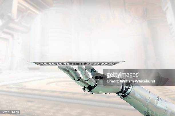 robot arm holding tray - butler stock pictures, royalty-free photos & images